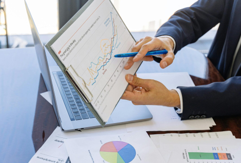 Free Business professionals discussing financial graphs and charts in an office setting. Stock Photo